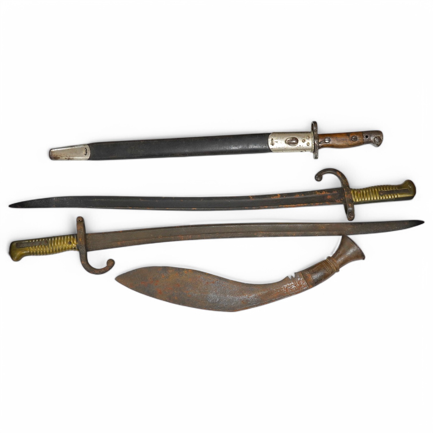 A Wilkinson bayonet and sheathe, two French bayonets and a kukri. Condition - fair